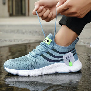 Blue athletic shoe with white sole being worn on a wet pavement surface