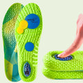 Green damping air cushion insoles with a hand touching one, on a green background.