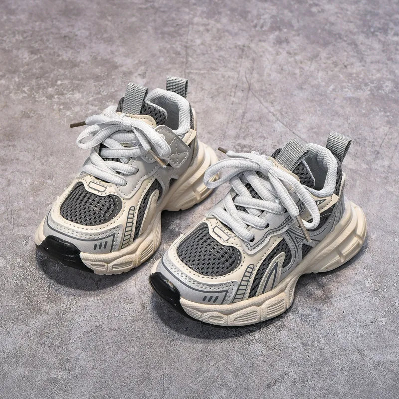 Pair of gray sneakers on a concrete surface