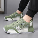 Green and white sneakers worn by a person on a gray floor.