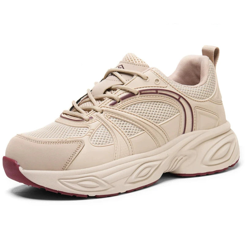 A beige women's work shoes sneaker with a chunky, sculpted sole, mesh panels, and subtle burgundy accents on the outsole and side details, shown against a plain white background.