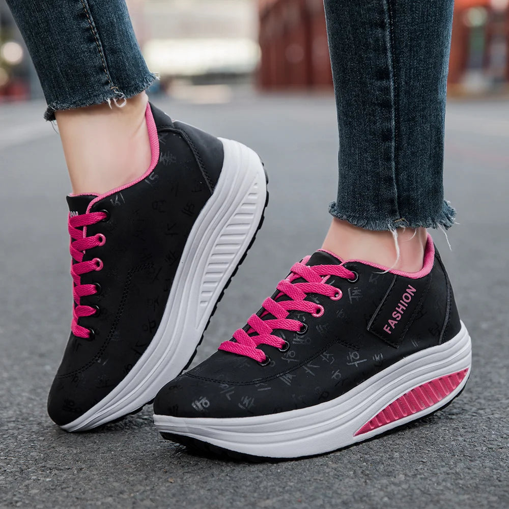 Red sneakers with white soles worn on a street.