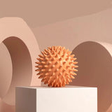 Orange spiked ball on a white platform with a beige background and '5 pcs' text.
