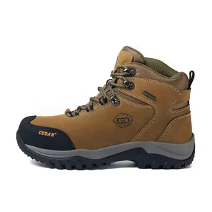 A tan and olive green mid-cut hiking boot with a dark navy toe cap and gray midsole, shown from a side profile on a white background.