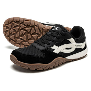 Black and white sneaker with brown sole on a white background