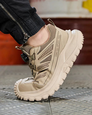 Beige safety work shoe with brand name on a textured surface